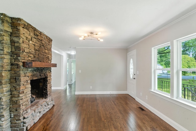 2207 Spencer Ave, Chattanooga, TN 37421 - unfurnished living room with dark wood-type flooring, ornamental molding, a fireplace, and a chandelier