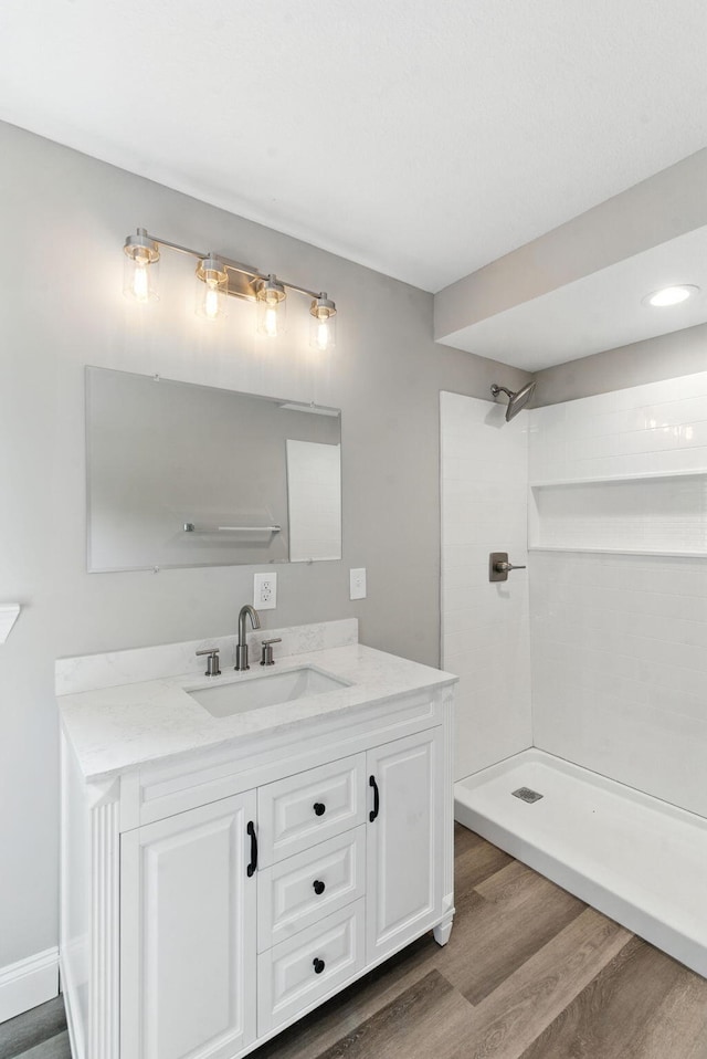 2207 Spencer Ave, Chattanooga, TN 37421 - bathroom with wood finished floors, vanity, and a tile shower