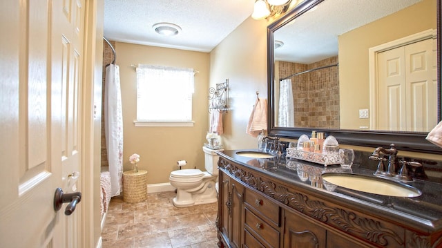 bathroom with vanity, a textured ceiling, toilet, and curtained shower