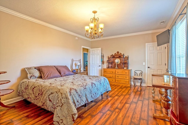 bedroom featuring a textured ceiling, crown molding, dark wood-type flooring, and an inviting chandelier