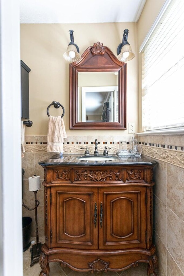 bathroom featuring vanity and tile walls