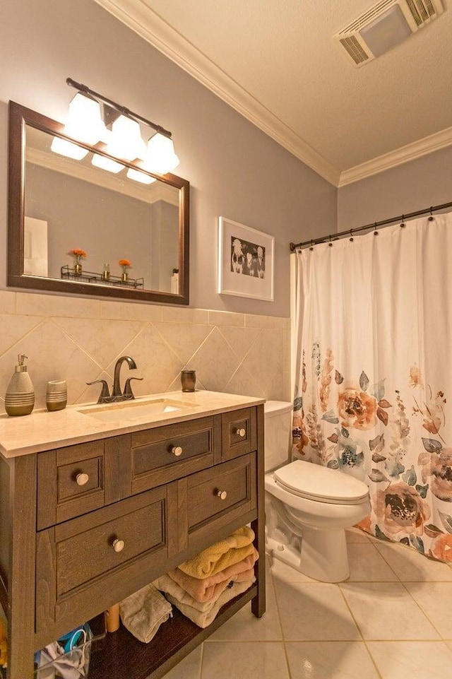 bathroom featuring toilet, vanity, tile patterned floors, and crown molding