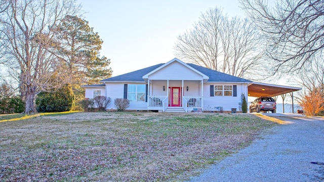 ranch-style home with a carport, covered porch, and a front yard