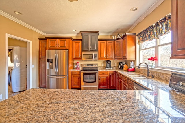 kitchen with crown molding, sink, light stone countertops, a textured ceiling, and appliances with stainless steel finishes