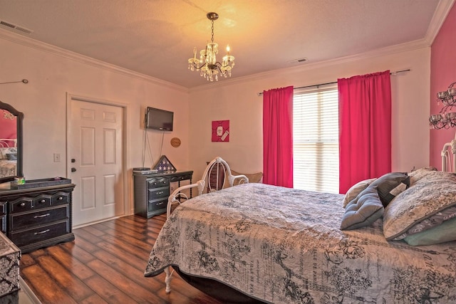 bedroom with a textured ceiling, a chandelier, dark hardwood / wood-style floors, and ornamental molding