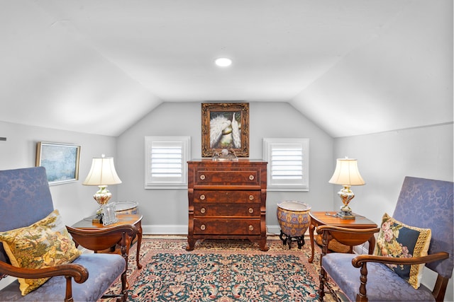 living area with a healthy amount of sunlight and lofted ceiling