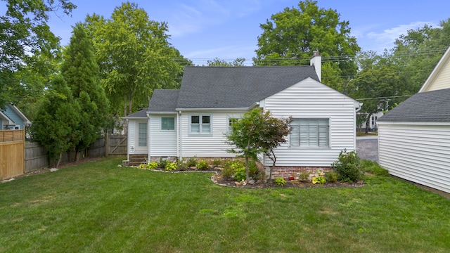 back of house with a lawn