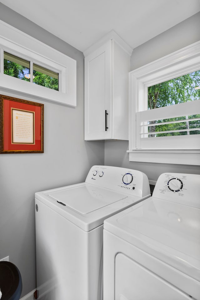 laundry area featuring cabinets and washing machine and clothes dryer