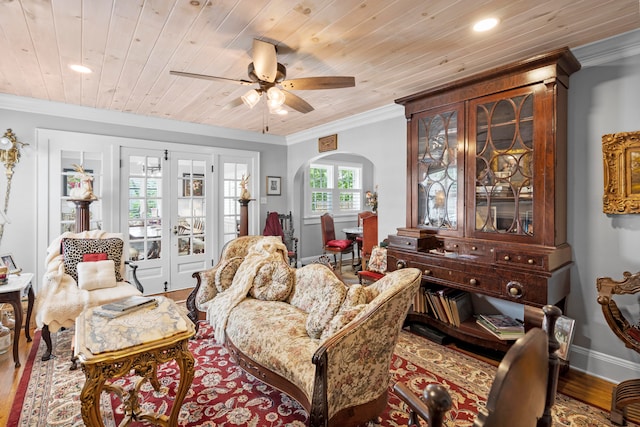 living room featuring french doors, wood ceiling, ceiling fan, crown molding, and hardwood / wood-style flooring