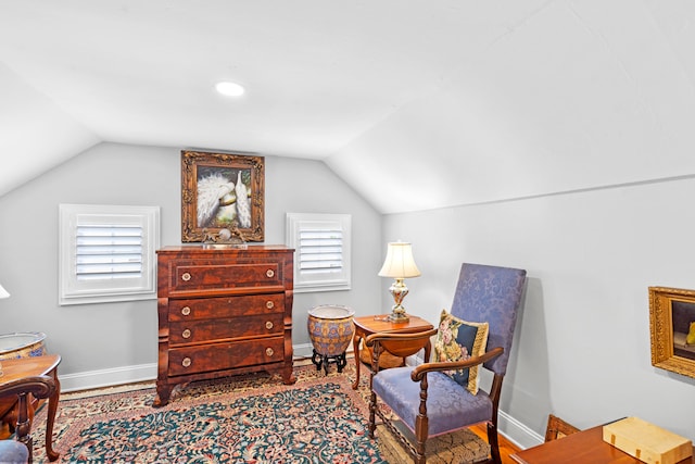 living area with hardwood / wood-style flooring and lofted ceiling