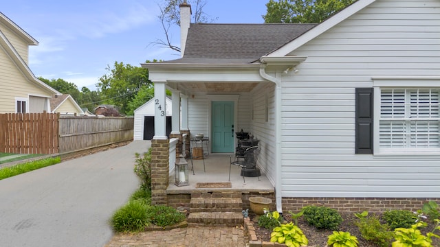 view of exterior entry with a porch