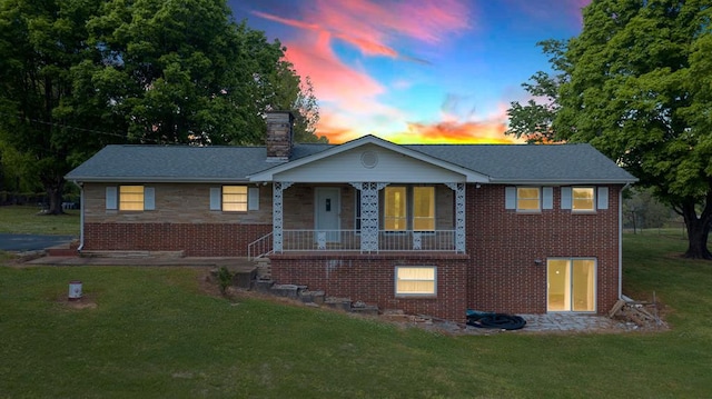 view of front facade with a yard and covered porch