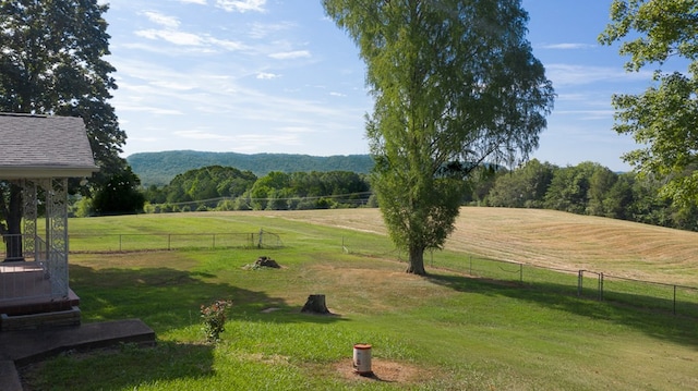 surrounding community featuring a lawn and a rural view