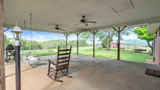 view of patio featuring a mountain view and ceiling fan