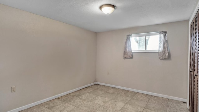 empty room featuring a textured ceiling