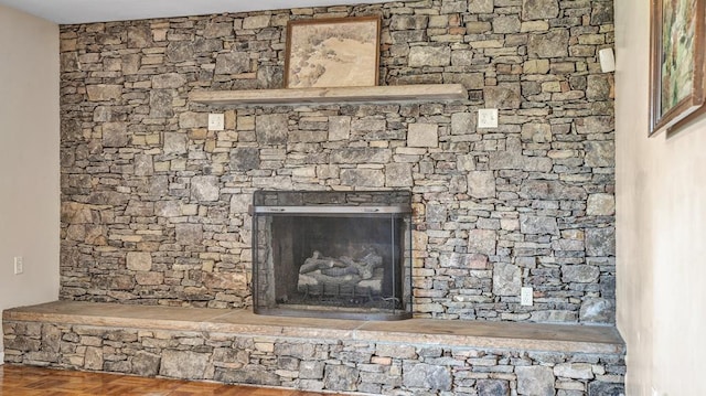 room details with a stone fireplace and parquet floors