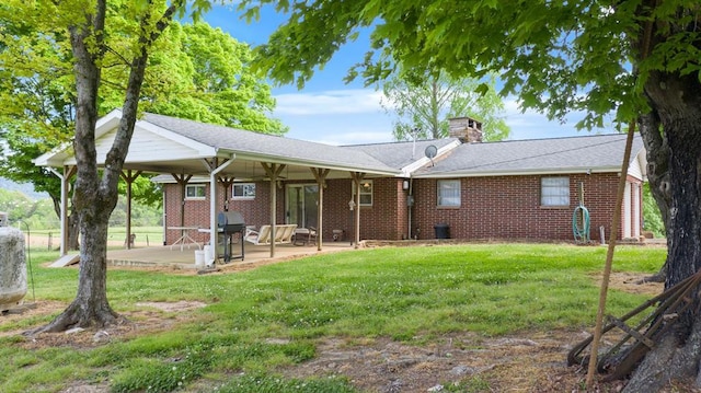 view of front of home with a patio and a front yard