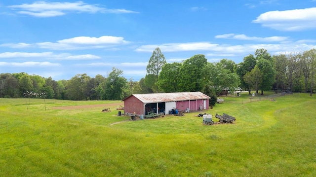 view of yard with a rural view and an outdoor structure