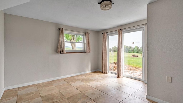 unfurnished room featuring plenty of natural light