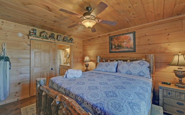 101 Hideaway Trl, Copperhill, TN 37317 - bedroom with a barn door, wood finished floors, wooden walls, and wooden ceiling