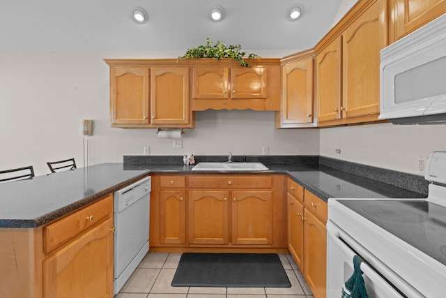 kitchen with white appliances, light tile patterned floors, sink, kitchen peninsula, and a breakfast bar area