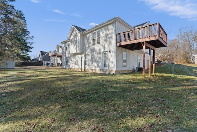 back of house featuring a wooden deck, a yard, and central AC