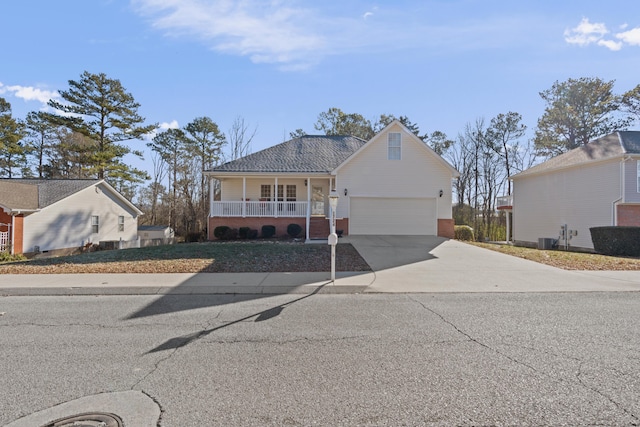 view of front facade with a garage, a porch, and central air condition unit