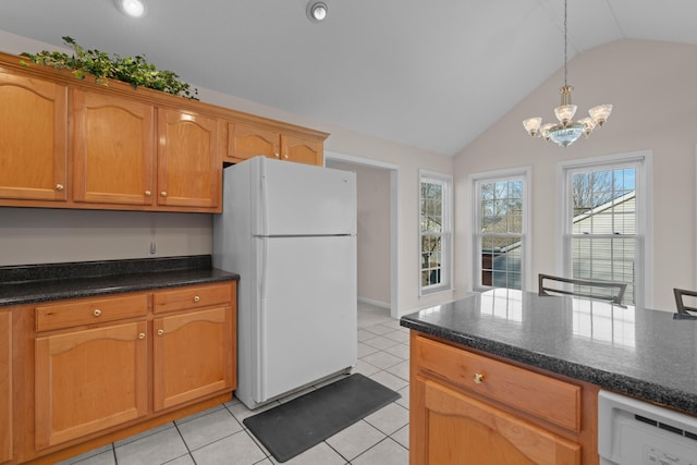 kitchen with vaulted ceiling, decorative light fixtures, light tile patterned floors, white appliances, and an inviting chandelier