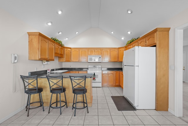 kitchen with kitchen peninsula, light tile patterned floors, white appliances, a breakfast bar area, and lofted ceiling