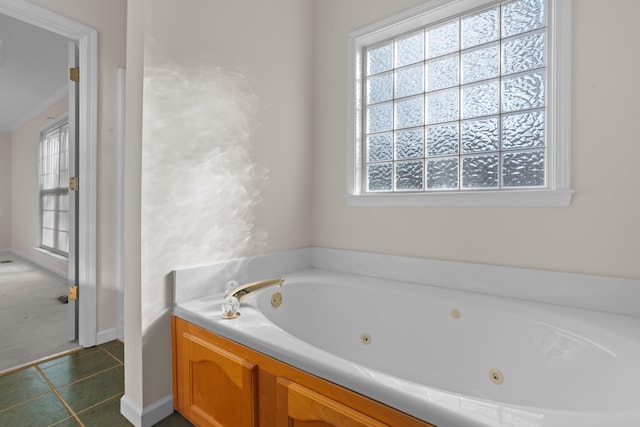 bathroom with a washtub and tile patterned flooring