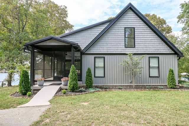 view of front of property with a sunroom and a front lawn