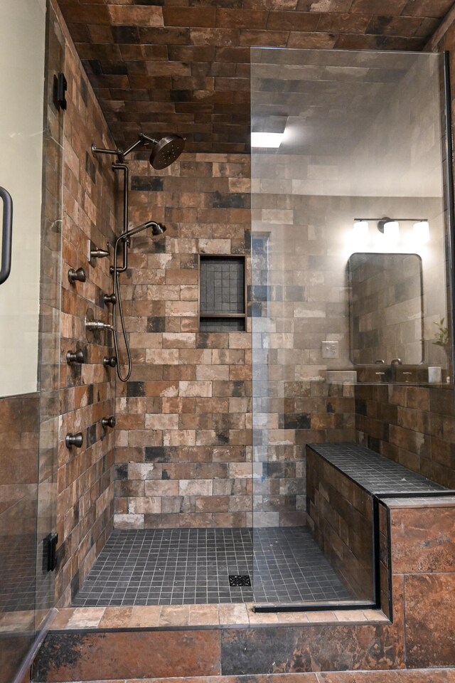 bathroom with a shower with door