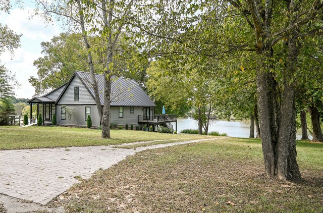 view of front of property with a front lawn and a water view