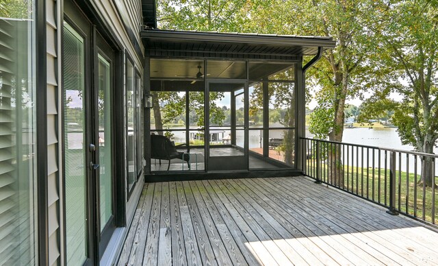 unfurnished sunroom with a water view