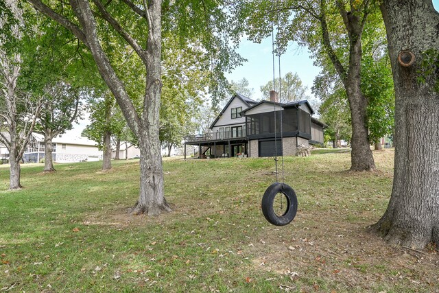 view of yard with a sunroom and a wooden deck