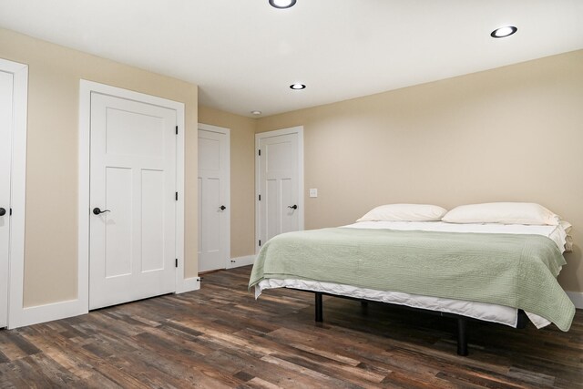 bedroom with dark wood-type flooring