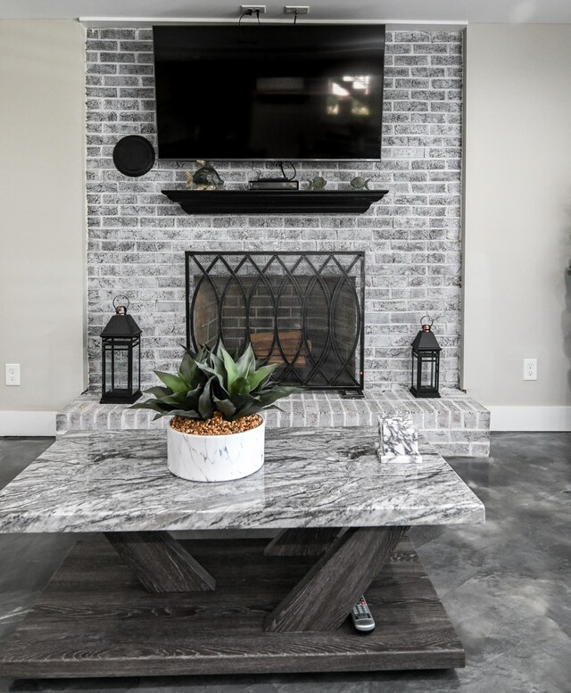 details featuring a fireplace and concrete floors