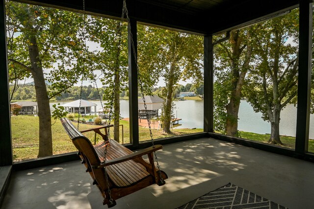 unfurnished sunroom featuring a healthy amount of sunlight and a water view