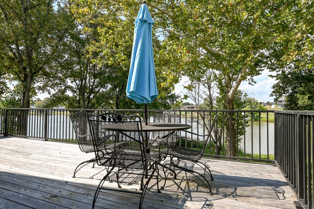 wooden deck featuring a water view