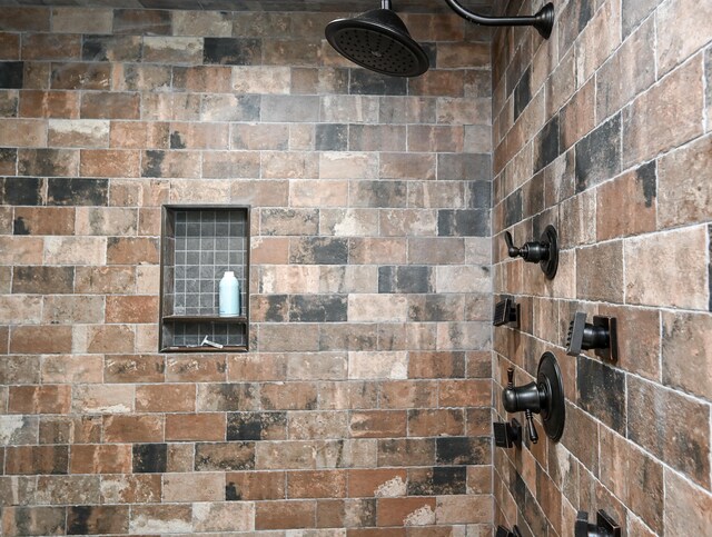 interior details featuring tiled shower