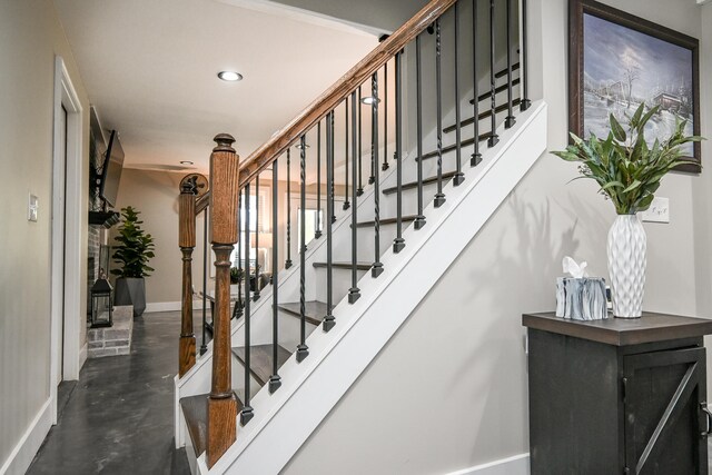 staircase with concrete floors