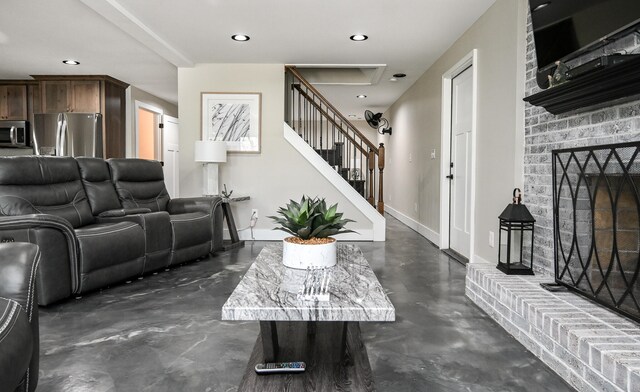 living room with a brick fireplace