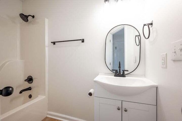 bathroom with  shower combination, vanity, and baseboards