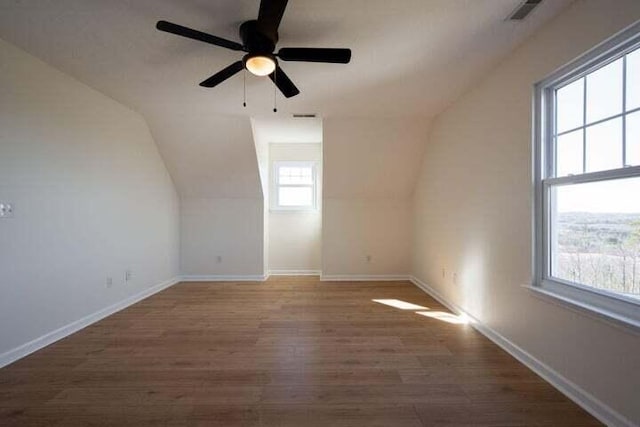 bonus room with visible vents, vaulted ceiling, baseboards, and wood finished floors