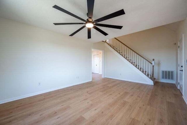 unfurnished living room with a ceiling fan, visible vents, stairs, baseboards, and light wood finished floors