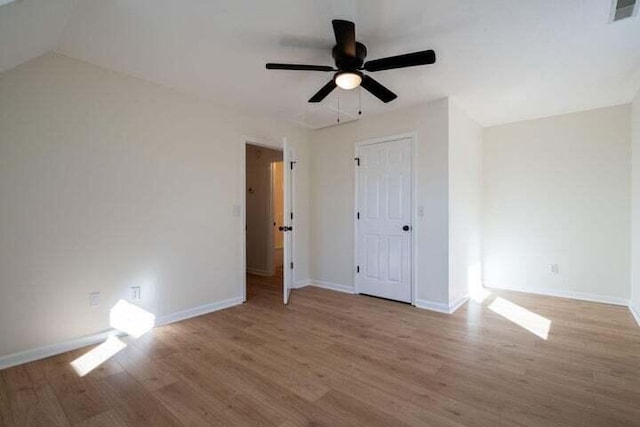 unfurnished bedroom with ceiling fan, wood finished floors, visible vents, and baseboards