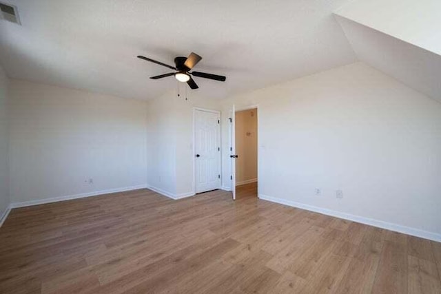 additional living space featuring lofted ceiling, baseboards, and wood finished floors