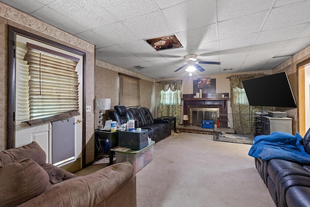 carpeted living room featuring a paneled ceiling and ceiling fan