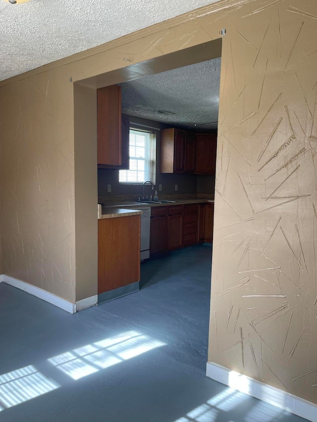 kitchen with sink and a textured ceiling