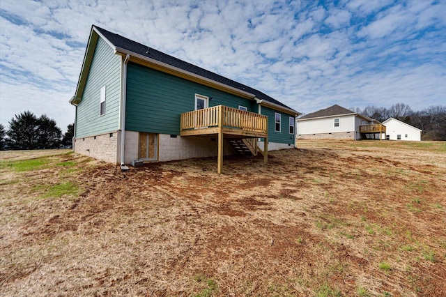 rear view of house featuring a wooden deck